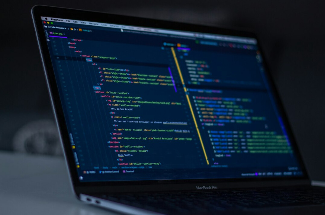 programmer coding on laptop